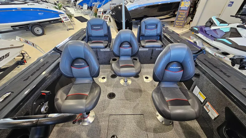Slide: The Image of 2021 Tracker Targa V-18 Combo boat interior with four seats in showroom. - 6
