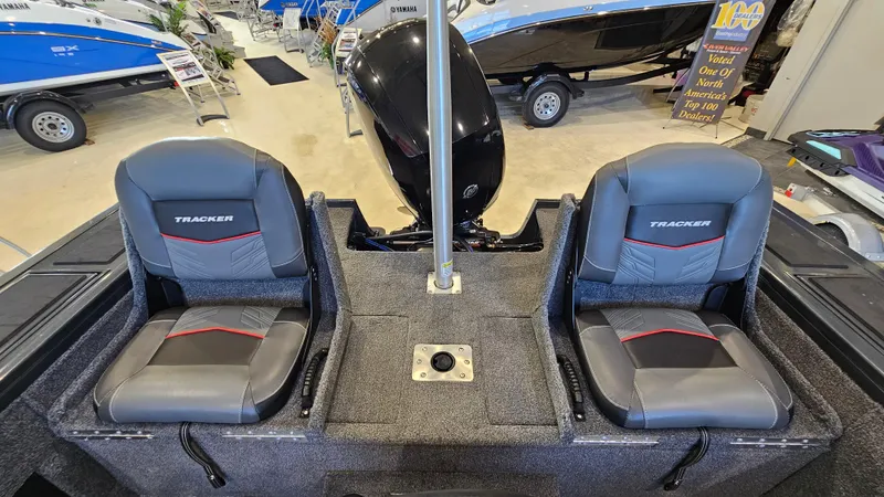 Slide: The Image of 2021 Tracker Targa V-18 Combo boat interior with two seats in showroom. - 8