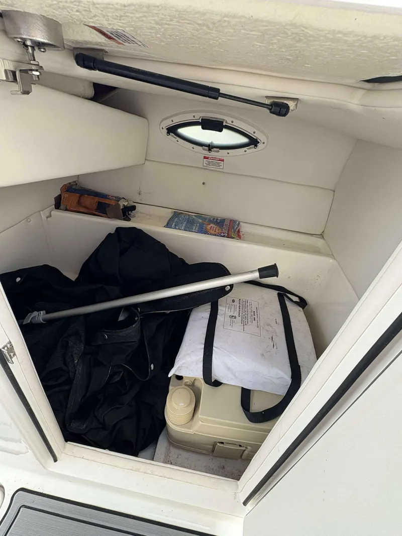 Slide: The Image of 2019 Bayliner VR6 storage compartment with equipment and supplies. - 10