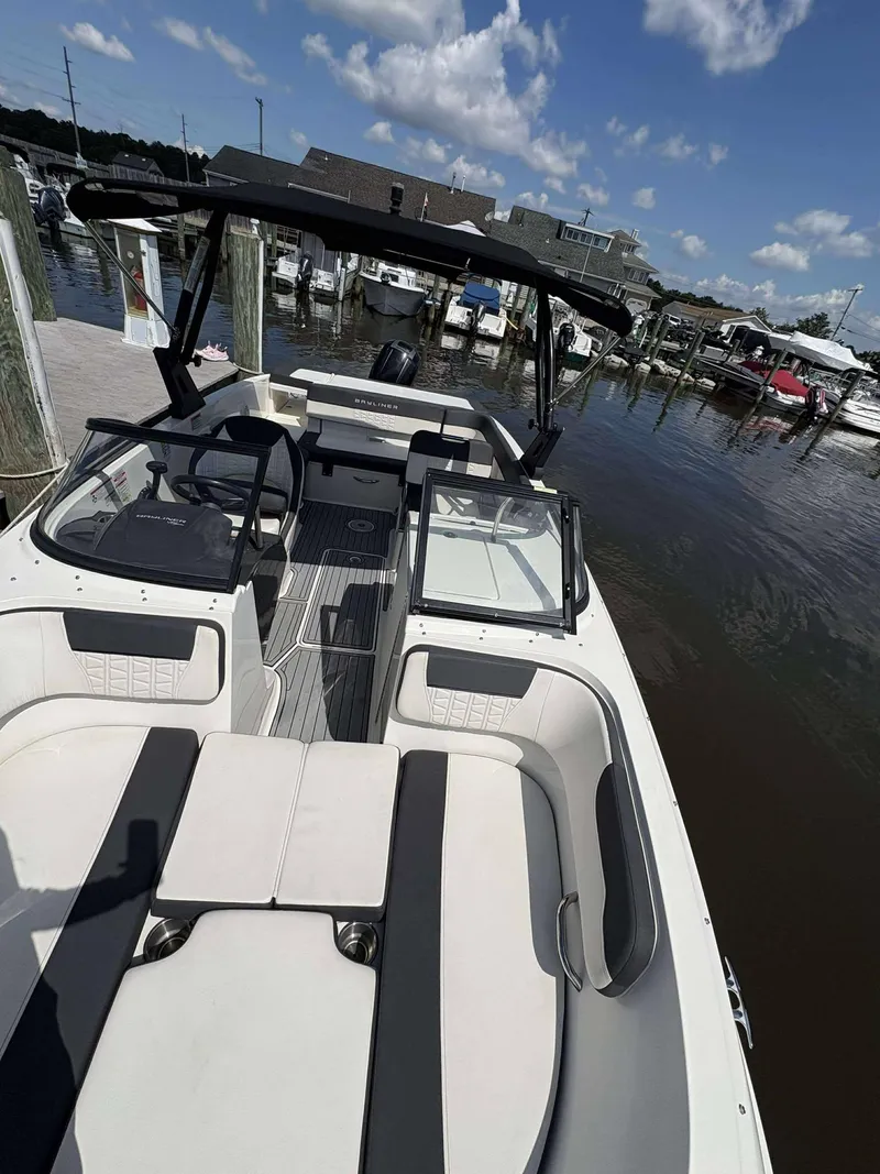 Slide: The Image of 2019 Bayliner VR6 boat docked at marina under blue sky. - 4