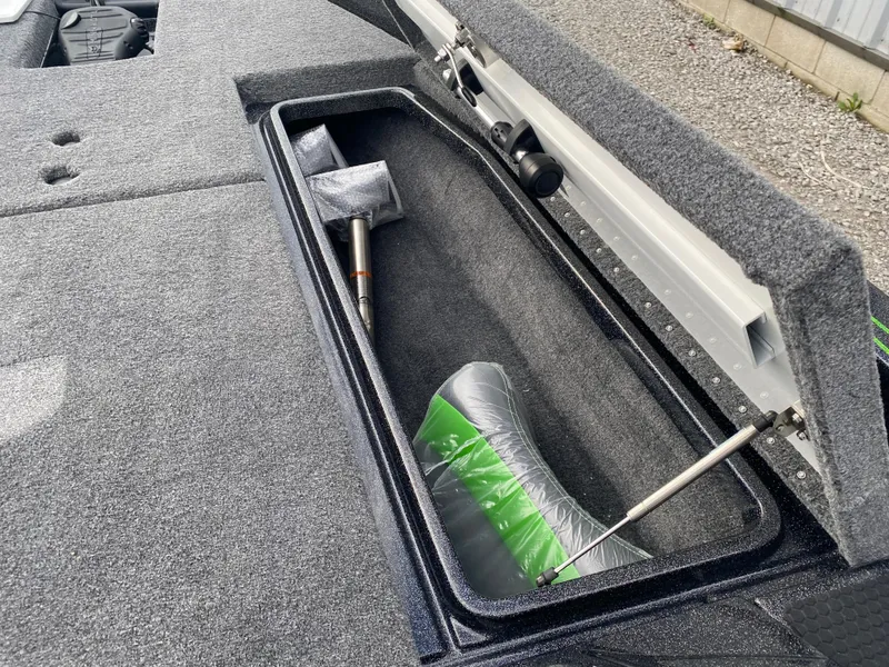 Slide: The Image of Open storage compartment in 2025 Phoenix 818 Pro boat, featuring organized equipment. - 13