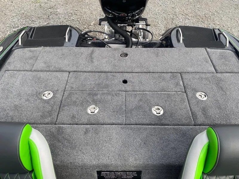 Slide: The Image of 2025 Phoenix 818 Pro boat deck with gray carpet and green-accented seats. - 18