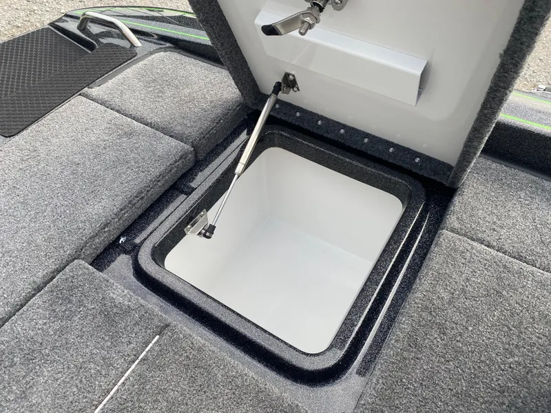 Slide: The Image of Open storage compartment in 2025 Phoenix 818 Pro boat, featuring carpeted interior and hydraulic lift. - 20