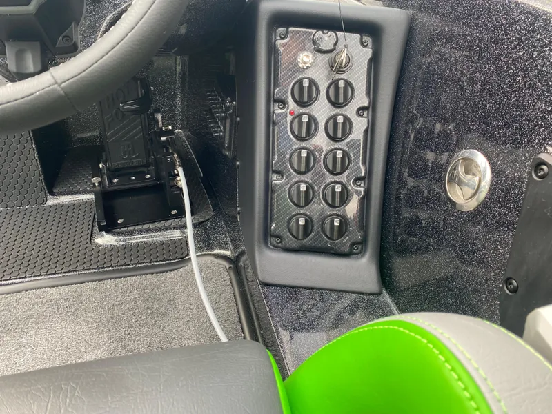 Slide: The Image of Interior control panel of 2025 Phoenix 818 Pro boat with switches and steering wheel. - 8