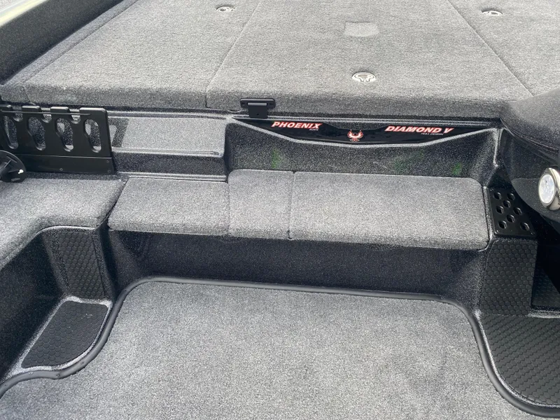 Slide: The Image of 2025 Phoenix 818 Pro boat interior with carpeted deck and storage compartments. - 9