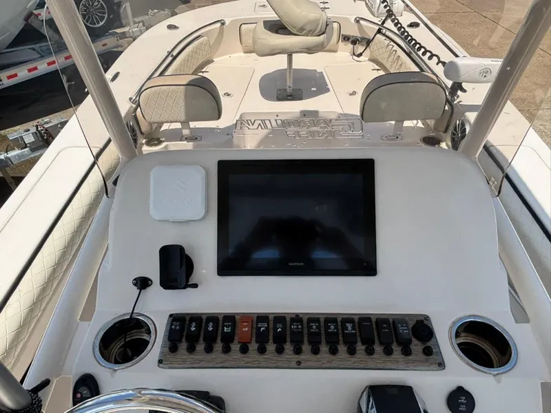 Slide: The Image of 2022 Carolina Skiff 26 Ultra Elite boat dashboard with controls and navigation screen. - 10