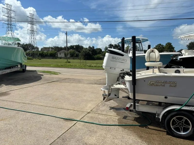 Slide: The Image of 2022 Carolina Skiff 26 Ultra Elite boat with Suzuki engine on a trailer. - 2