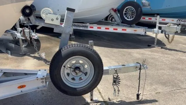 Slide: The Image of Trailer for 2022 Carolina Skiff 26 Ultra Elite boat, featuring sturdy wheel and hitch. - 20