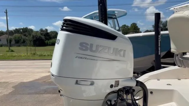 Slide: The Image of 2022 Carolina Skiff 26 Ultra Elite with Suzuki outboard motor, parked outdoors. - 22