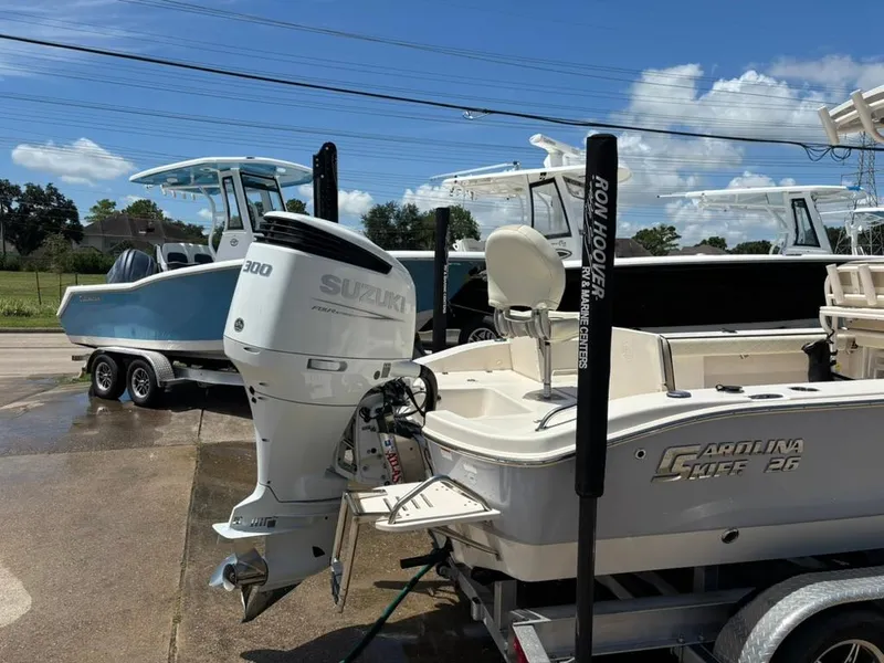 Slide: The Image of 2022 Carolina Skiff 26 Ultra Elite boat with Suzuki 300 engine, parked on a trailer. - 3