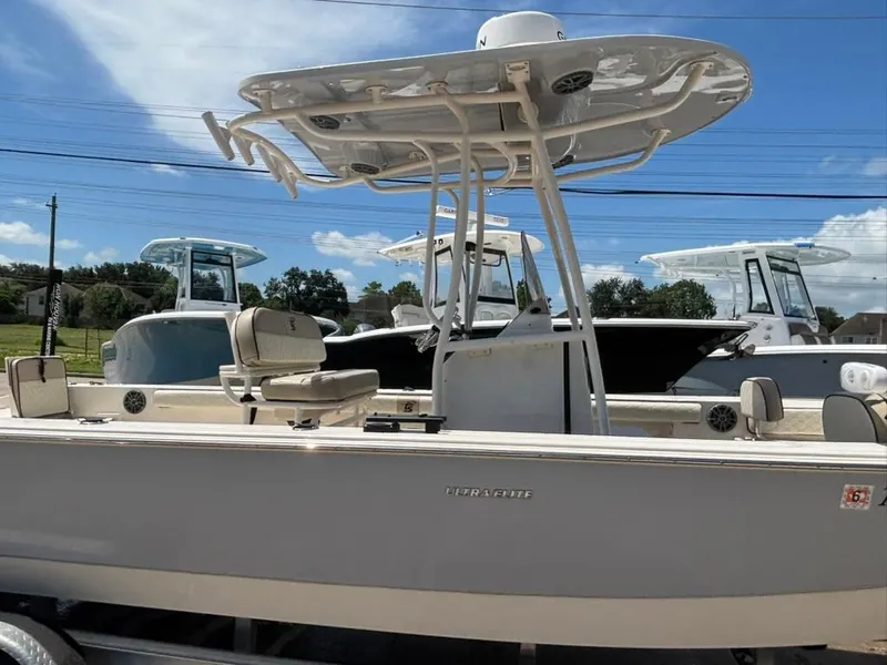 Slide: The Image of 2022 Carolina Skiff 26 Ultra Elite boat with T-top, parked outdoors under blue sky. - 6