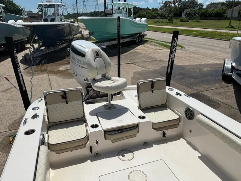 Slide: The Image of 2022 Carolina Skiff 26 Ultra Elite boat interior with seating and Suzuki outboard motor. - 7