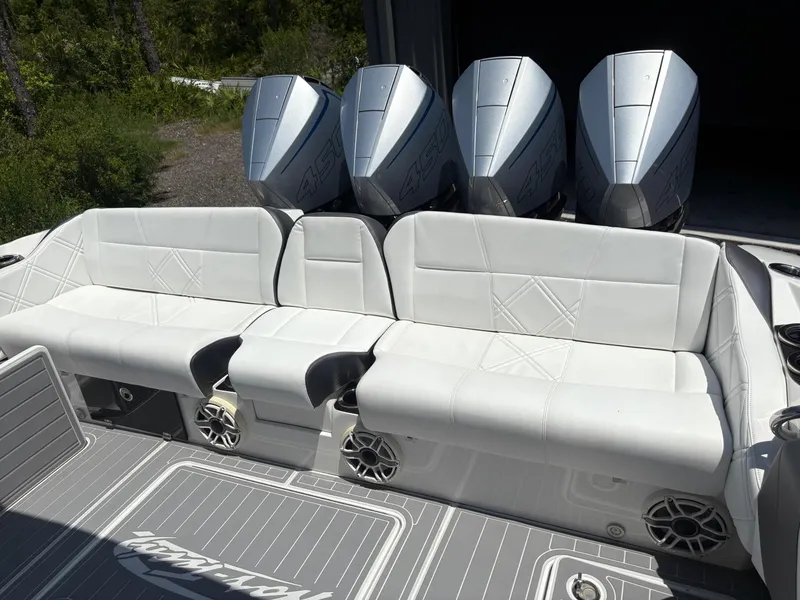 Slide: The Image of 2020 Nor-Tech 450 Sport Center Console with white seating and four powerful outboard engines. - 13