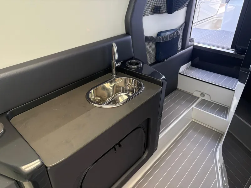 Slide: The Image of 2020 Nor-Tech 450 Sport Center Console interior with sink and storage area. - 14