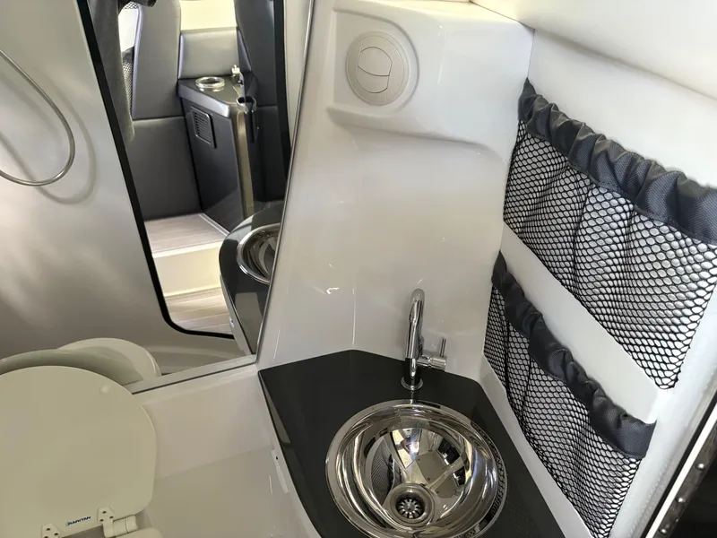 Slide: The Image of 2020 Nor-Tech 450 Sport Center Console interior with sink and storage nets. - 15