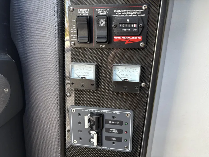 Slide: The Image of Control panel of a 2020 Nor-Tech 450 Sport Center Console boat with gauges and switches. - 17