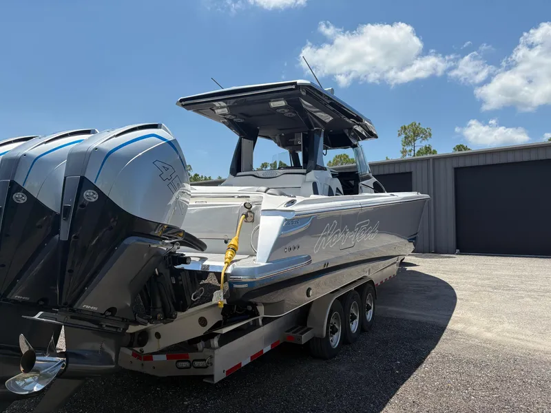 Slide: The Image of 2020 Nor-Tech 450 Sport Center Console boat on trailer, featuring powerful outboard engines. - 3