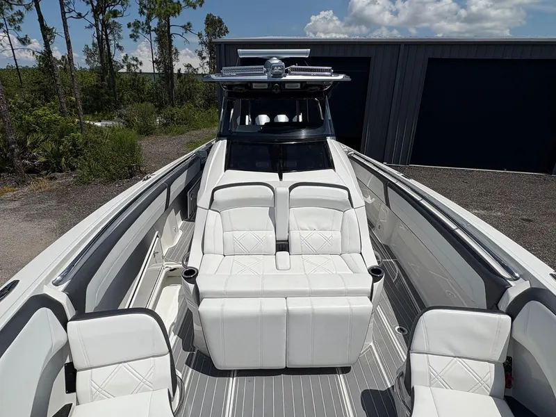 Slide: The Image of 2020 Nor-Tech 450 Sport Center Console with luxurious white seating and sleek design. - 8