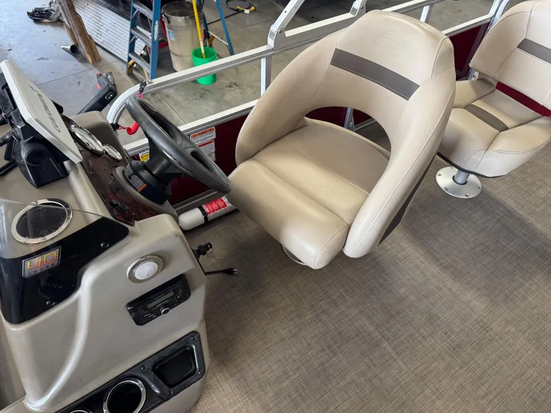 Slide: The Image of 2023 Sun Tracker Bass Buggy 18 DLX boat interior with steering console and seating. - 13