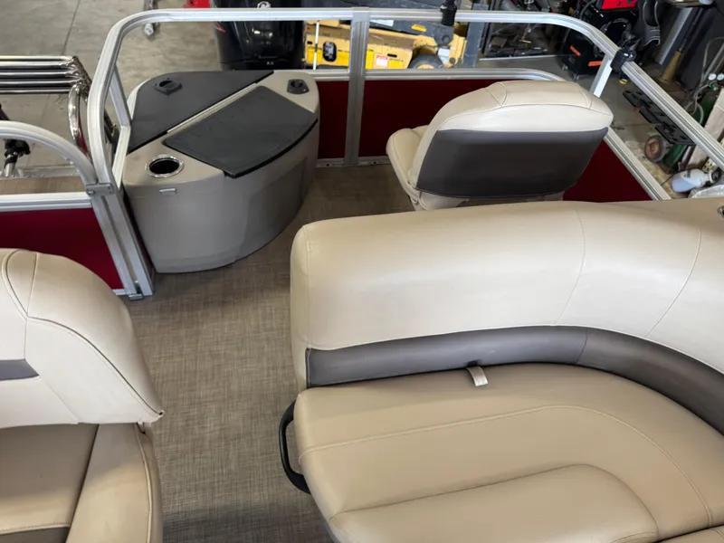 Slide: The Image of 2023 Sun Tracker Bass Buggy 18 DLX interior with beige seating and storage area. - 15