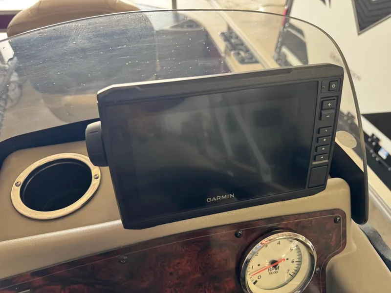 Slide: The Image of Garmin display and RPM gauge on 2023 Sun Tracker Bass Buggy 18 DLX boat console. - 19