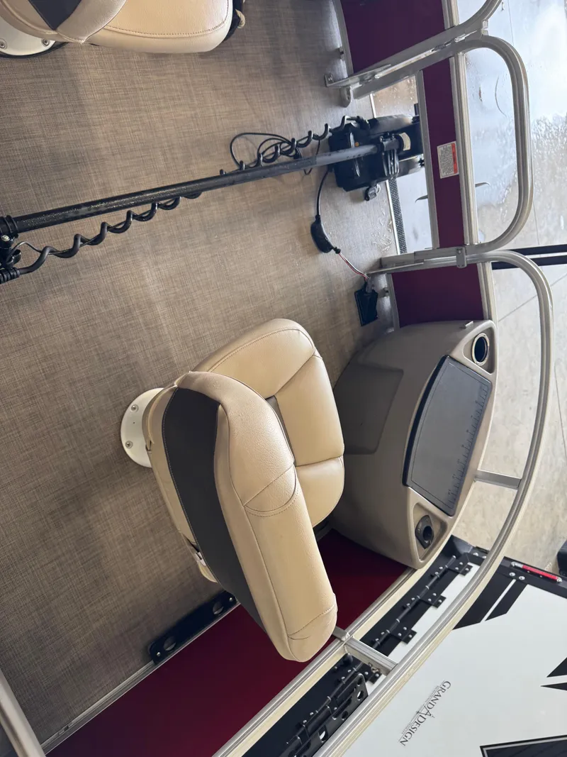 Slide: The Image of 2023 Sun Tracker Bass Buggy 18 DLX interior with beige seating and control panel. - 5