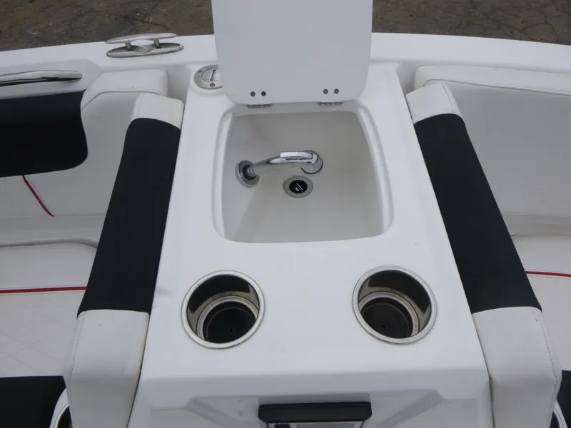 Slide: The Image of Interior of 2022 Tahoe 1950 boat featuring a sink and cup holders. - 10