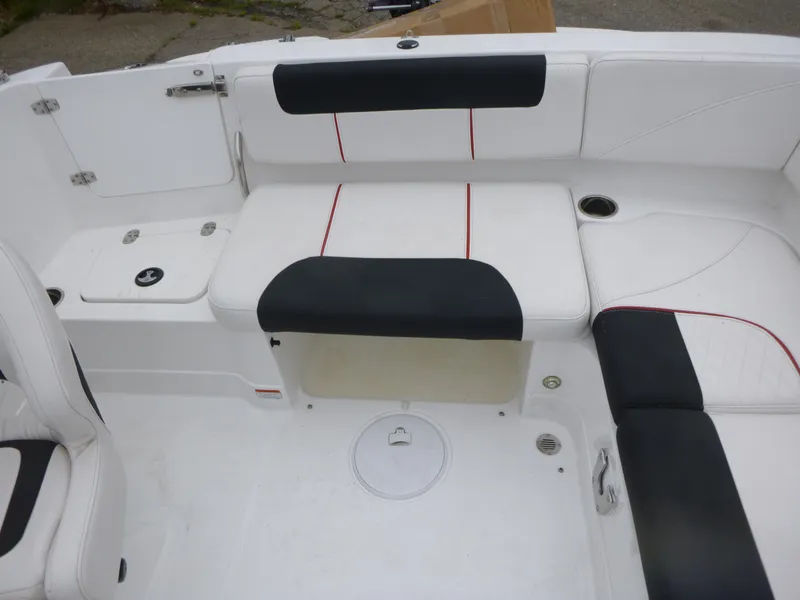 Slide: The Image of Interior seating of a 2022 Tahoe 1950 boat, featuring white and black upholstery. - 13
