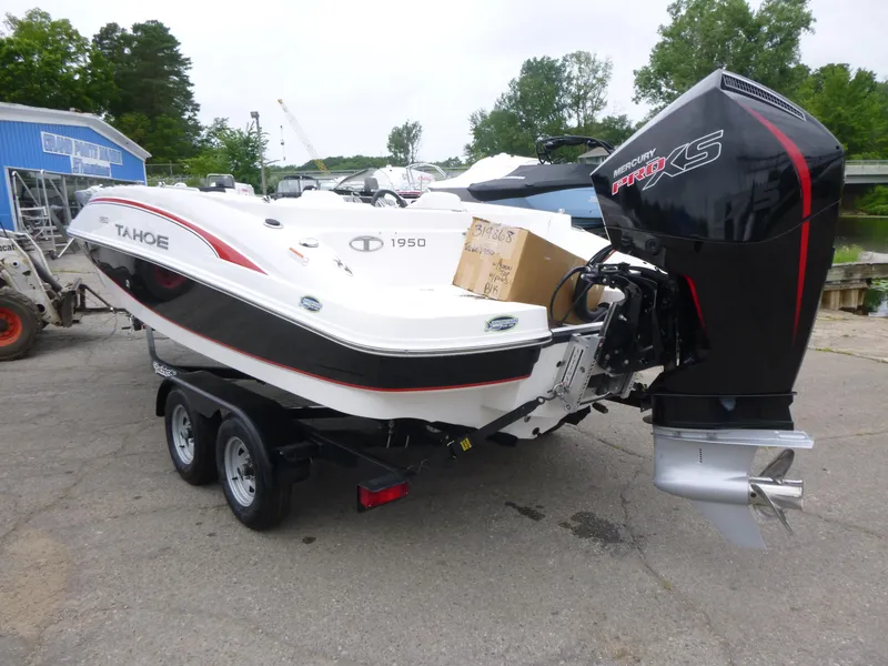 Slide: The Image of 2022 Tahoe 1950 boat with Mercury Pro XS engine on trailer, parked outdoors. - 3