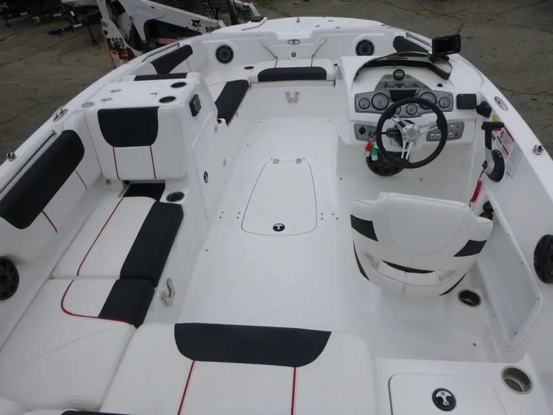 Slide: The Image of Interior of a 2022 Tahoe 1950 boat with white and black seating. - 5