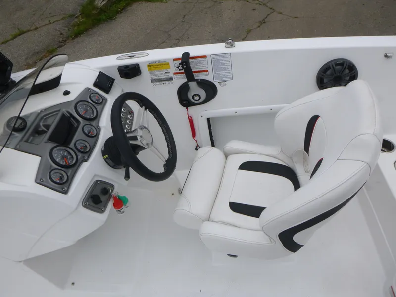 Slide: The Image of Cockpit of 2022 Tahoe 1950 boat with steering wheel and white captain's chair. - 7