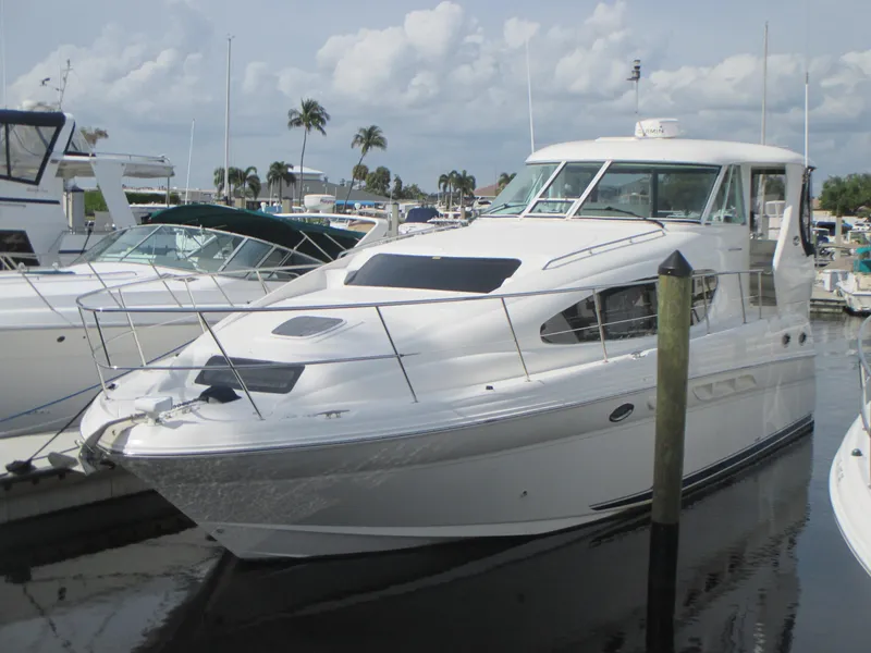 The Image of 2005 Sea Ray 390 Motor Yacht docked near palm trees and a marina. - 0