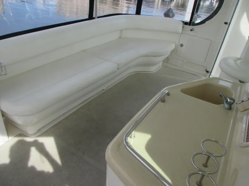 Slide: The Image of Interior seating area of a 2005 Sea Ray 390 Motor Yacht with white upholstery. - 13