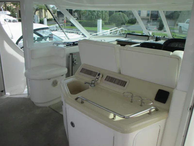 Slide: The Image of 2005 Sea Ray 390 Motor Yacht interior helm with seating and sink. - 18