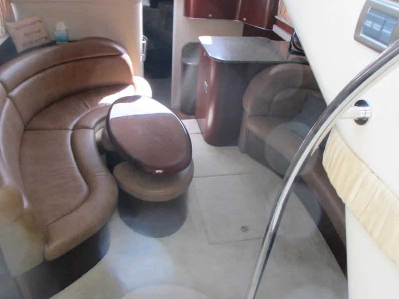 Slide: The Image of Interior of 2005 Sea Ray 390 Motor Yacht with plush seating and wooden table. - 24