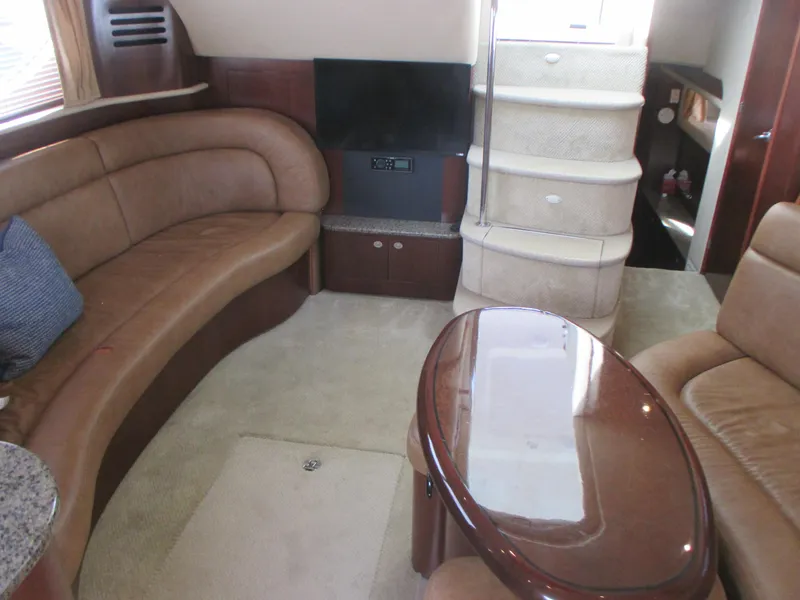 Slide: The Image of Interior of 2005 Sea Ray 390 Motor Yacht with plush seating and elegant wooden table. - 28