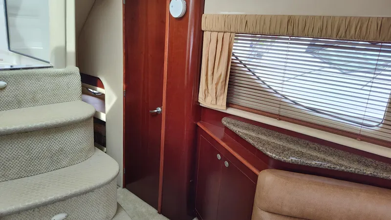 Slide: The Image of Interior of 2005 Sea Ray 390 Motor Yacht with stairs, wooden cabinetry, and window blinds. - 35