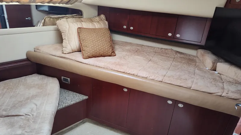 Slide: The Image of 2005 Sea Ray 390 Motor Yacht cabin with bed and storage cabinets. - 40