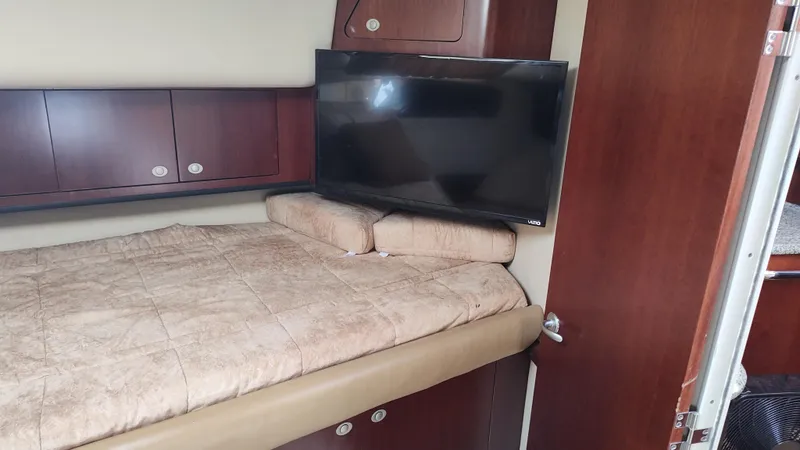 Slide: The Image of 2005 Sea Ray 390 Motor Yacht bedroom with TV and storage cabinets. - 41