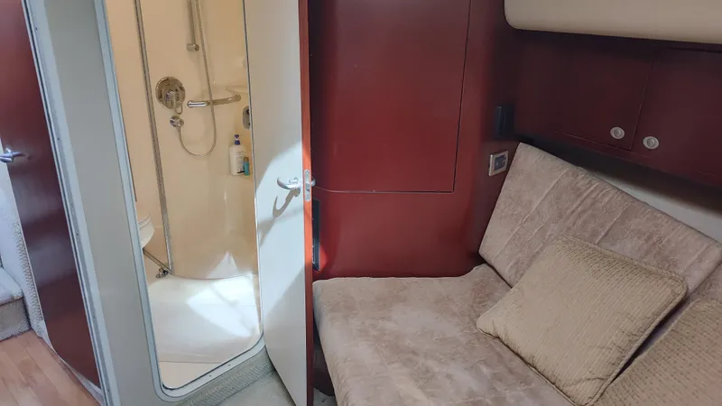 Slide: The Image of 2005 Sea Ray 390 Motor Yacht interior with beige sofa and bathroom. - 42