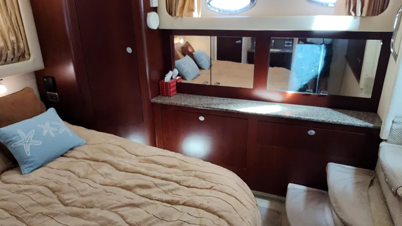 Slide: The Image of Luxurious bedroom interior of 2005 Sea Ray 390 Motor Yacht with cozy bedding and wooden cabinetry. - 47