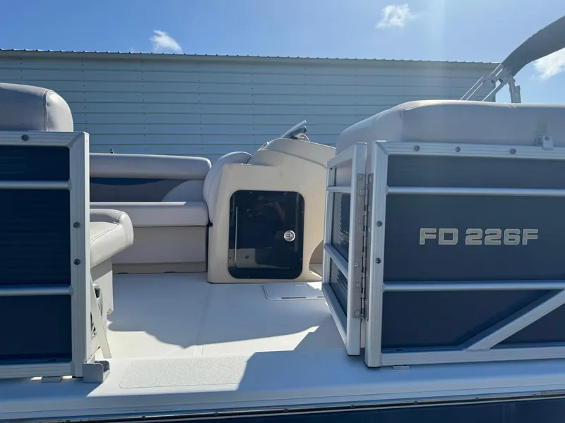 Slide: The Image of 2018 Hurricane FunDeck 226F OB boat interior with seating and storage compartment. - 1