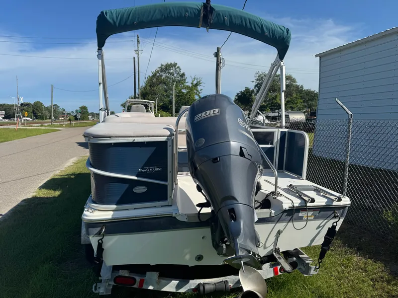 Slide: The Image of 2018 Hurricane FunDeck 226F OB boat with Yamaha outboard motor, parked on a trailer. - 2