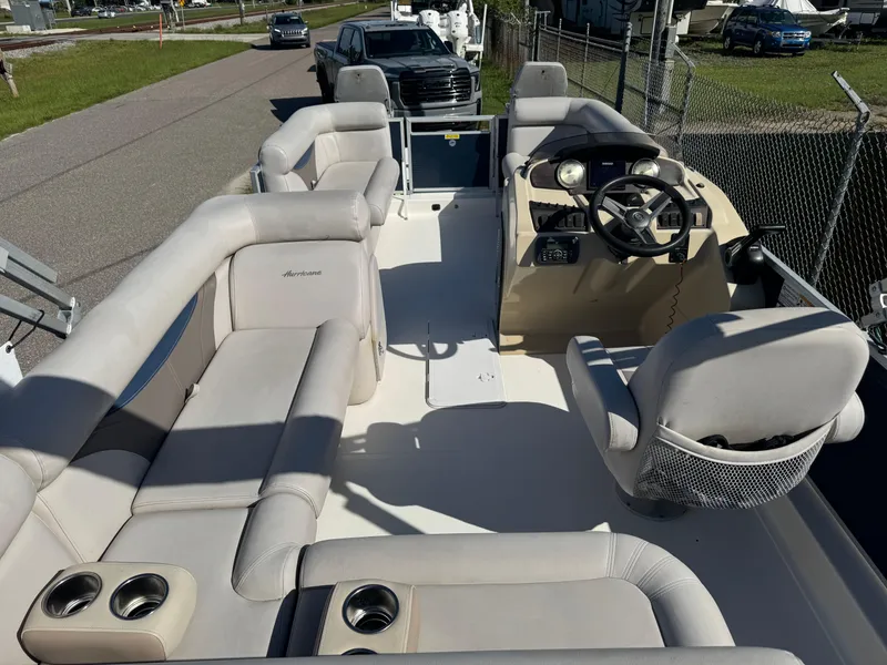 Slide: The Image of 2018 Hurricane FunDeck 226F OB boat interior with plush seating and steering console. - 3