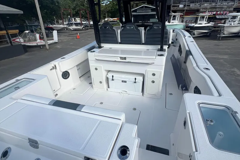 Slide: The Image of 2025 Robalo R300 Center Console boat interior with seating and storage compartments. - 18