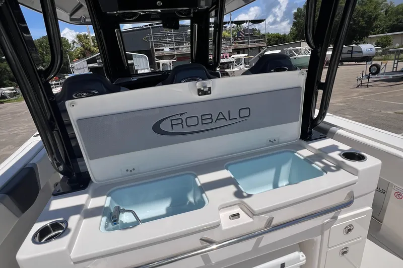 Slide: The Image of 2025 Robalo R300 Center Console boat with dual livewells and sleek design. - 21