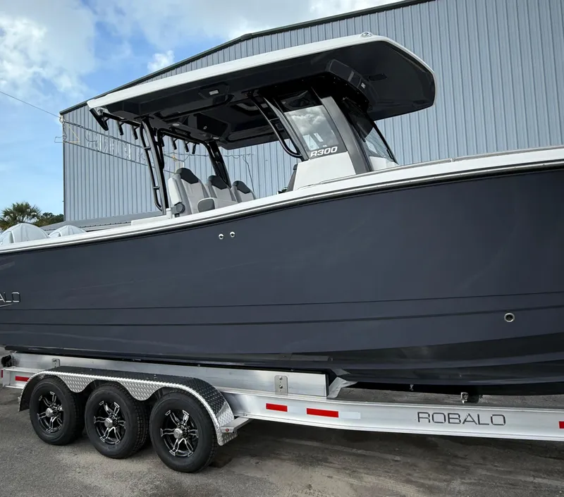 Slide: The Image of 2025 Robalo R300 Center Console boat on trailer, side view. - 4