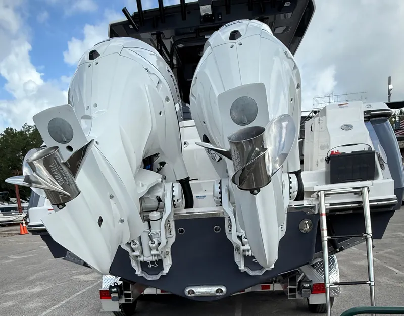 Slide: The Image of 2025 Robalo R300 Center Console with dual outboard engines, rear view. - 6