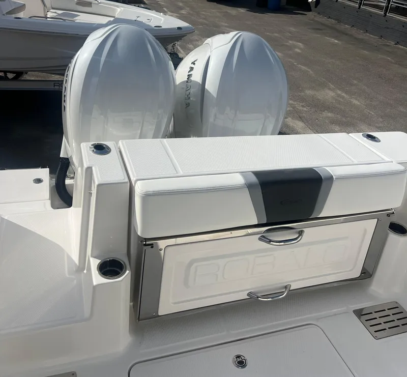 Slide: The Image of 2025 Robalo R300 Center Console boat with dual Yamaha engines, rear seating, and storage. - 9
