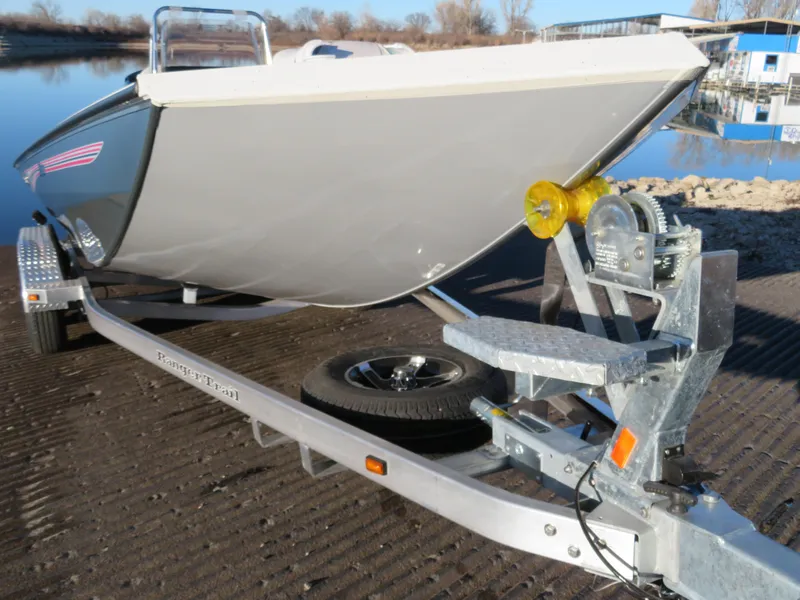 Slide: The Image of 2024 Ranger RB200 boat on trailer by a lake, ready for launch. - 15